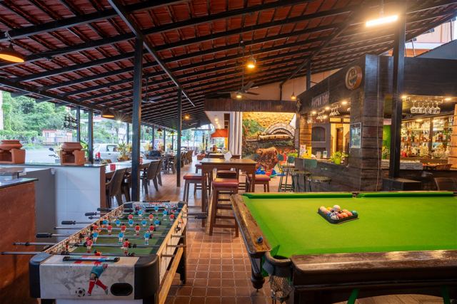 Bar and games area with foosball and pool table
