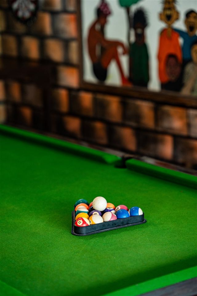 Pool balls racked on green baize
