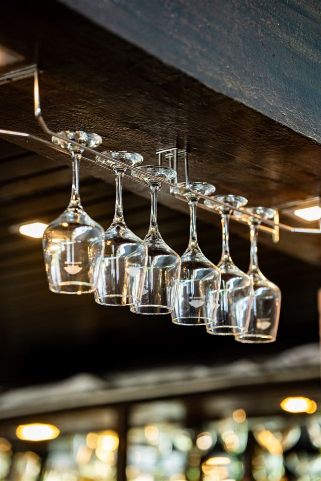 Wine glasses hanging above the bar