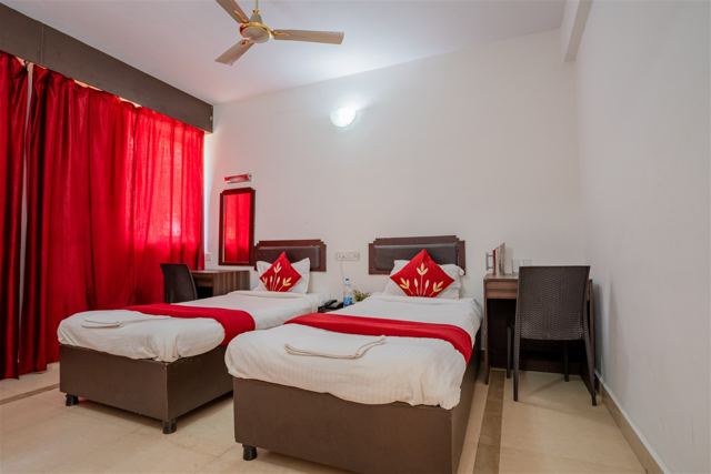 Twin bed room with red curtains